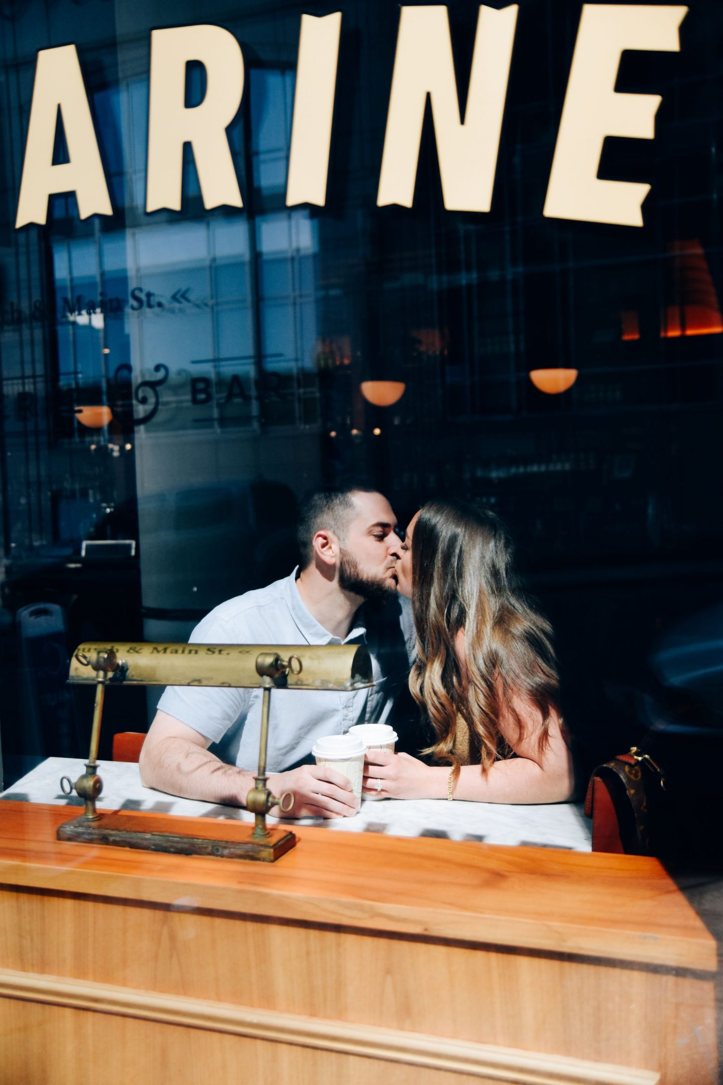 Couple Kissing in Coffee Shop