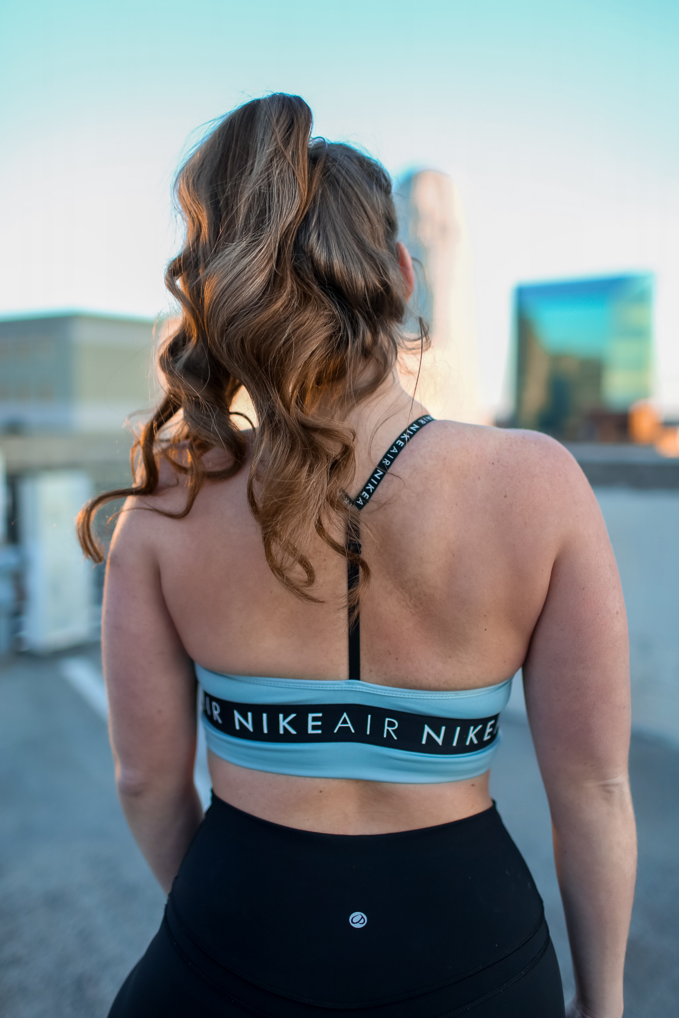 Back view of Woman in Nike Air Sports bra