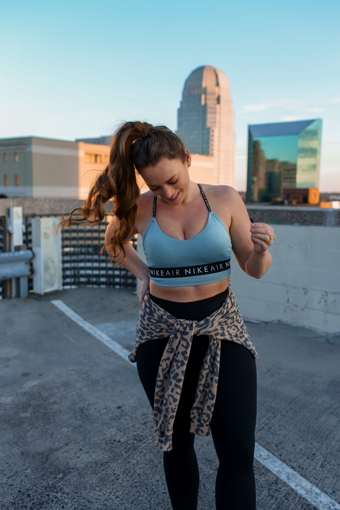 Women in fitness outfit with leopard pull over 